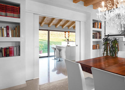 Here an Eclisse double pocket door is used to link an elegant kitchen area to a dining area.